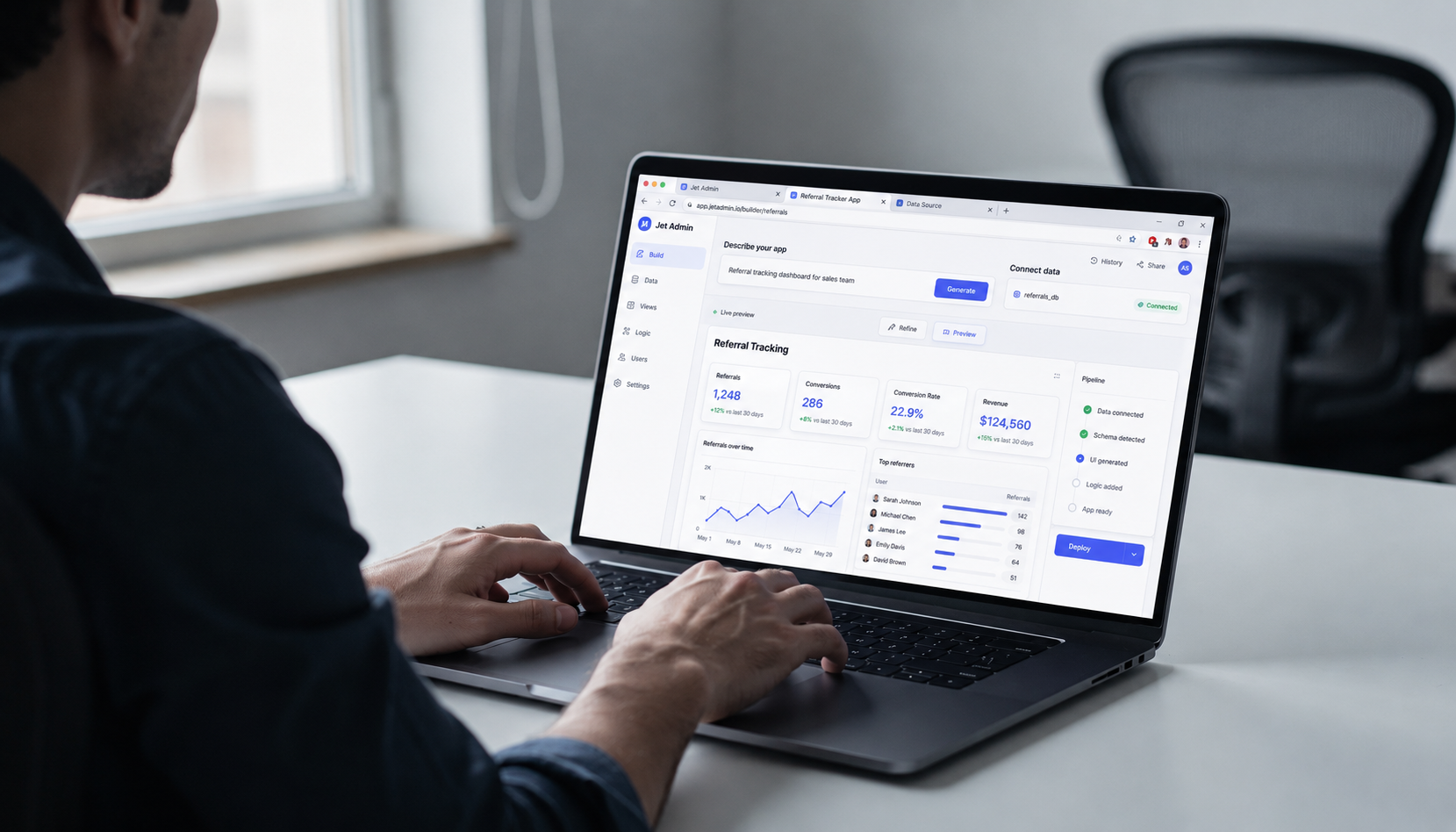 A person is working at a laptop with multiple browser tabs open, displaying a web application interface that showcases various features and tools. The scene captures the essence of a lovable team engaged in a project to build apps and improve user experience.