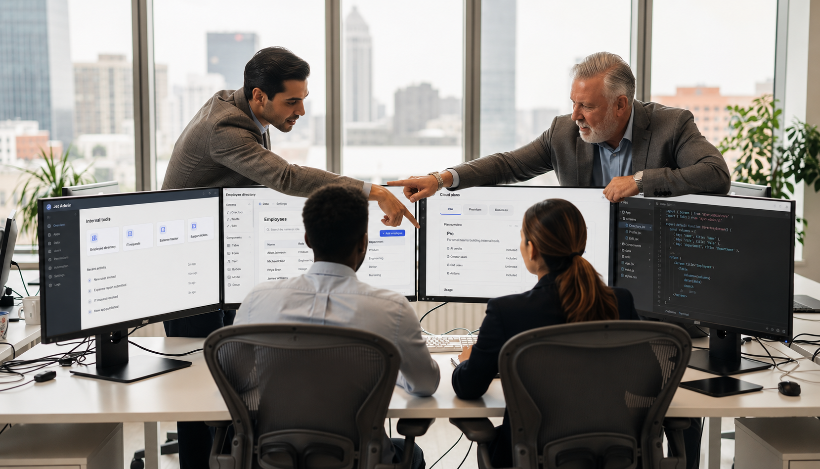 A small team is collaborating around multiple monitors in a modern office, utilizing a low code platform to build internal tools. They are actively discussing features such as the drag and drop interface and custom components, emphasizing the importance of data security and user groups in their project.