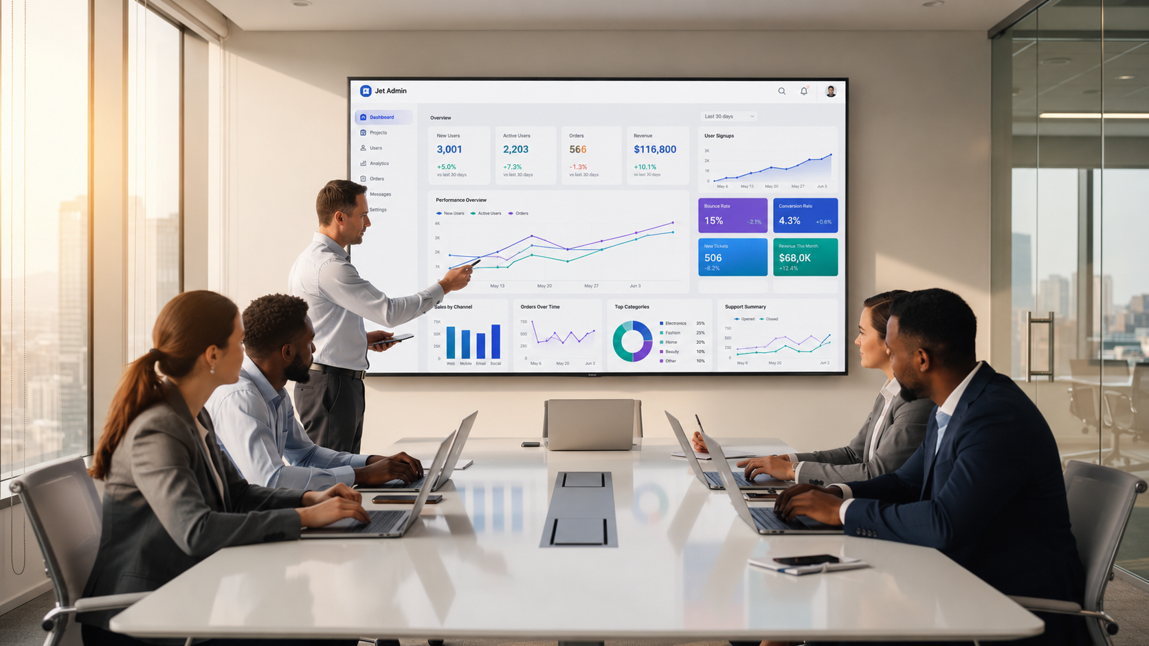 A diverse team is gathered around a conference table, each with laptops open, as they review a dashboard application displayed on a large screen. The setting emphasizes team collaboration and the development workflow, highlighting the use of tools for building full stack web apps and internal tools.