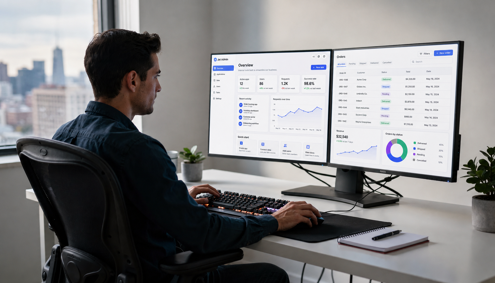 A developer is seated at a desk, focused on dual monitors that showcase vibrant data dashboards and detailed table views, reflecting the functionality of internal tools and custom applications. The setup emphasizes rapid development and advanced features, suitable for managing complex workflows and integrating various data sources.